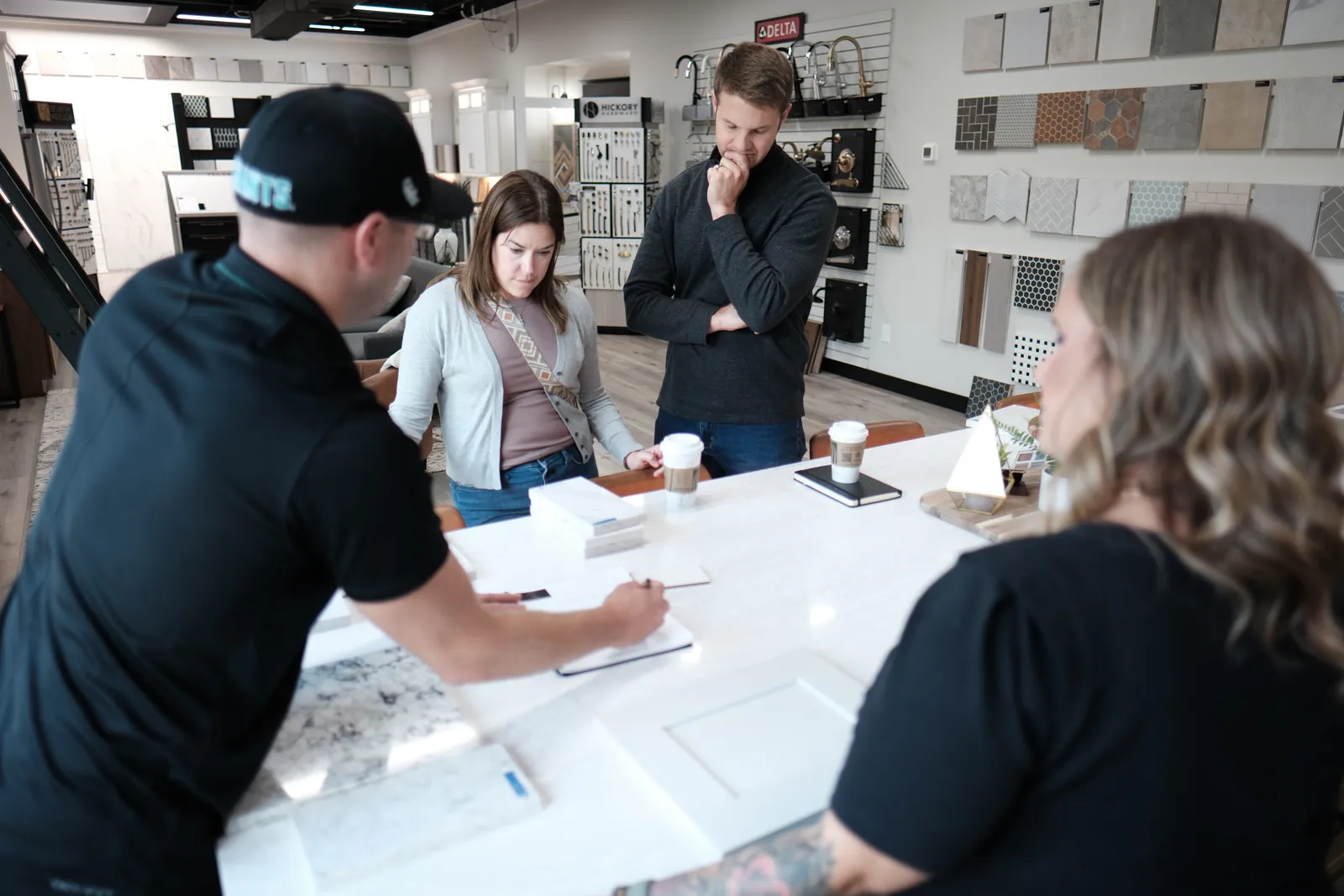 Taylor reviewing finishes with clients at the showroom design table