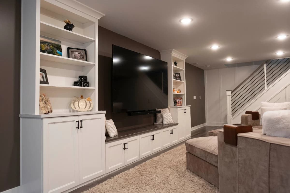 Finished basement living space with built-in entertainment center